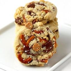 two cookies are stacked on top of each other, with nuts and pecans in the middle