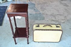 two pieces of luggage sitting on the ground next to each other in a garage area