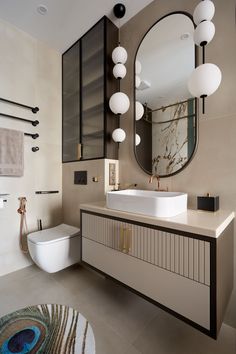 a bathroom with a large mirror, sink and toilet in the middle of it's room