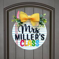 a door sign with a yellow bow on it that says, mrs miller's class