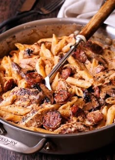 a skillet filled with pasta and meat