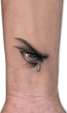 a woman's foot with an eye tattoo on it