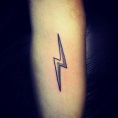 a black and white lightning tattoo on the leg