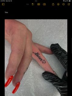 a woman's hand with a tattoo on it and the words i love you