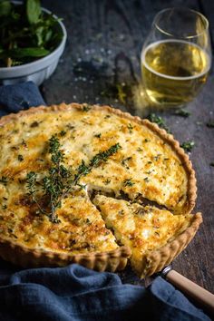 a quiche with cheese and herbs on a wooden table