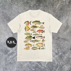 Vintage 90s Fish Shirt ⭐ Welcome to K & K Custom Tees! ⭐  - Indulge in pure comfort with our Comfort Colors Shirt. Soft, relaxed, and available in a variety of colors! ⭐SHIRT DETAILS⭐  -High Quality fabric  -100% ring-spun US cotton -Designed and printed in the USA  ⭐ PLEASE NOTE ⭐ -For an oversized look, we suggest to size up 1-2 sizes. These shirts run like standard unisex tees. Please see size chart for a more fitted look!  -Colors may vary based on your monitor or screen display! ⭐CARE INSTR Short Sleeve Fish Print T-shirt For Fishing, Graphic Print Shirt For Fishing In Summer, Fish Print Crew Neck Top For Fishing, Cotton Tops With Fish Print For Fishing, Fish Shirt, Vintage Graphic Tees, Graphic Tees Vintage, Fishing T Shirts, Vintage Graphic