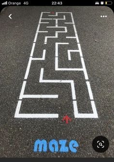 an image of a maze on the ground with blue marker and red arrow pointing to it