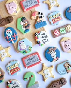 decorated cookies are displayed on a table for children's birthdays and baby showers