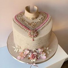 a white cake with pink flowers on top