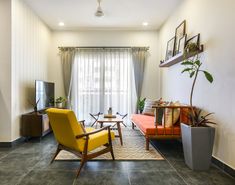 a living room filled with furniture and a flat screen tv on top of a wooden stand