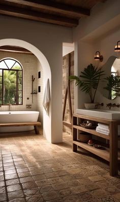 a large bathroom with an arched doorway leading to the outside, and a bathtub