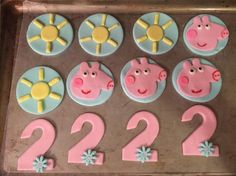 the cupcakes are decorated with pink and blue frosting, including two pigs