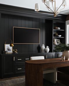 an office with black walls and gold accents