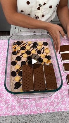 a woman is making desserts with chocolate and marshmallows