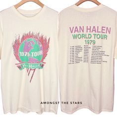 an old t - shirt with the tour dates printed on it is hanging on a wooden hanger