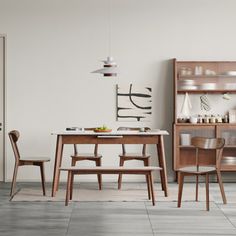 a dining room scene with focus on the table and chairs