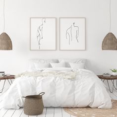 a bedroom with white walls and two paintings on the wall above the bed, next to a wicker basket