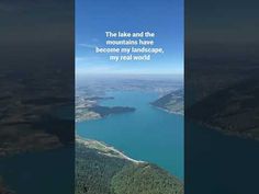 an aerial view of a lake and mountains with a quote written on the bottom right corner