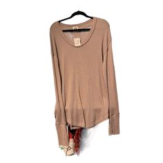 This, We The People, Women's T-Shirt In Olive Green Is Perfect For The Fall And Winter Seasons. The Long Sleeves With Thumbholes And Relaxed Fit Make It A Comfortable And Practical Choice For Travel Or Casual Occasions. The Scoop Neck And Pullover Closure Add A Touch Of Style To The Solid Pattern. Made Of Cotton Fabric, This T-Shirt Is Machine Washable For Easy Care. The We Brand Ensures High Quality. Add This Versatile Piece To Your Wardrobe Today! Fall T-shirt With Shirttail Hem, Cotton Tops With Shirttail Hem For Fall, Crew Neck Shirt For Layering In Fall, We The People, Green Long Sleeve, Solid Pattern, Fall And Winter, The Fall, Free People Tops