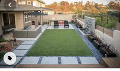 an outdoor patio with grass and seating area