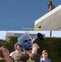 a man with blue hair holding a megaphone to his face