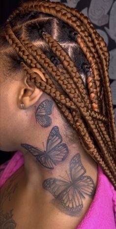 a woman with butterfly tattoos on her neck