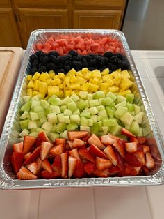 a tray filled with sliced fruit on top of a counter