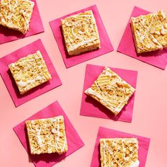 six square pieces of cake on pink napkins