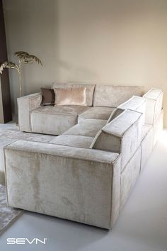 a white couch sitting in the middle of a living room