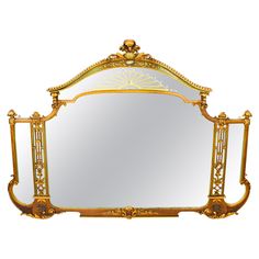 an ornately decorated mirror with gold trimmings