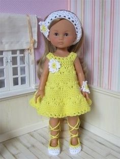 the doll is wearing a yellow dress with white flowers