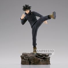 the action figure is posed on top of a rock and has his legs spread out