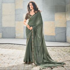 Olive Green colored saree is prettified with printed & gota patti work as shown which makes it appear classy. This saree is made of georgette fabric which is accompanied with georgette blouse piece which you can customise as per your design/style. Women can buy this saree to wear for their casual, daily and homely events and ideal for any fashionista. Note:- The actual product may differ slightly in color and design from the one illustrated in the images when compared with computer or mobile scr Festival Georgette Pre-draped Saree With Printed Border, Fitted Georgette Blouse Piece With Printed Border, Navratri Georgette Blouse Piece With Printed Border, Fitted Georgette Traditional Wear With Printed Border, Bollywood Georgette Traditional Wear With Printed Border, Bollywood Traditional Wear In Georgette With Printed Border, Pista Green Georgette Pre-draped Saree For Navratri, Traditional Chiffon Pre-draped Saree For Eid, Bollywood Style Chiffon Blouse Piece For Navratri