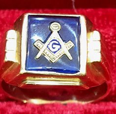 This is a very nice Masonic ring from the 1950s.  The master mason symbol is set in a deep blue  imitation sapphire stone .  The  setting is I believe 10K gold, with ribbing on the sides.  On the underneath of the band is the tiny Swank pentagon and stylized S, together with a capital K but I can't  see a number. Classic Blue Signet Ring Stamped 14k, Blue Antique Signet Ring For Formal Occasions, Antique Blue Hallmarked Signet Ring, Classic Hallmarked Blue Signet Ring, Classic Blue Hallmarked Signet Ring, Formal Blue Engraved Signet Ring, Ring Blue Stone, Masonic Ring, Blue Stone Ring