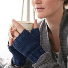 a woman holding a coffee cup in her hands