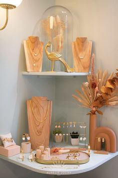 a table with vases, candles and other decorative items on it in a room