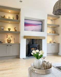 a living room filled with furniture and a fire place in front of a flat screen tv