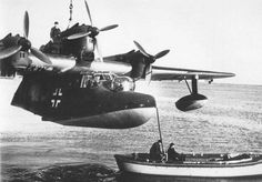 an old photo of two planes flying over the ocean