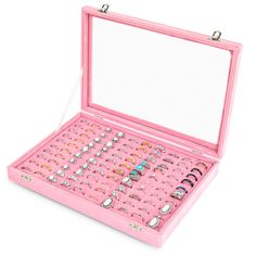 an open pink jewelry box filled with lots of rings