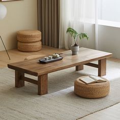 a living room scene with focus on the coffee table and plant in the centerpiece