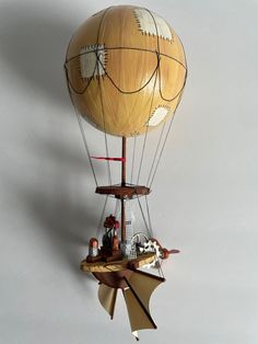 a wooden hot air balloon with people inside