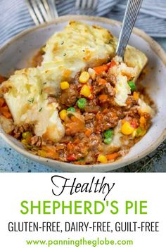 a bowl filled with shepherd's pie on top of a table