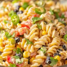 a bowl filled with pasta salad on top of a table