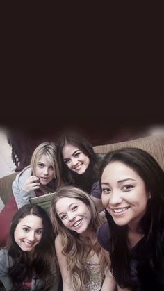 a group of young women sitting next to each other on top of a couch together