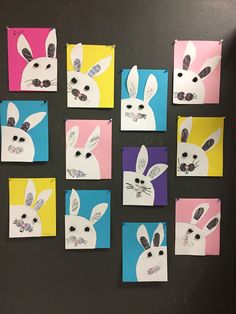 several different colored paper pictures on a blackboard with white rabbit's faces painted on them