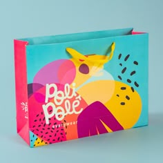 a colorful paper bag with the words peu pale on it and an image of a bird