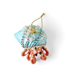 an ornament is hanging from a string on a white background with beads and pearls