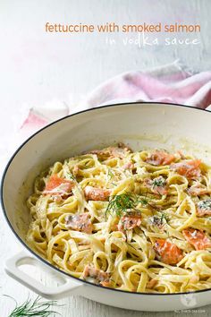 a white bowl filled with pasta and meat