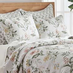 the comforter is made up and has flowers on it