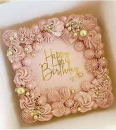 a pink birthday cake in a box with flowers and pearls on the top, happy birthday